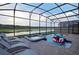 Beautiful screened-in pool area with lounge chairs and lake view at 4213 Paragprah St, Kissimmee, FL 34746