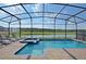 Beautiful screened-in pool area with lounge chairs and lake view at 4213 Paragprah St, Kissimmee, FL 34746