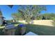 A fenced in back yard featuring healthy green grass, large trees, and an open area at 4357 Babbling Brook Way, Kissimmee, FL 34746
