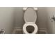 A clean and well-maintained white toilet with elevated base within a neutral-colored bathroom at 4357 Babbling Brook Way, Kissimmee, FL 34746