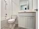 Bright bathroom featuring a tiled shower and white vanity with a mirror at 4357 Babbling Brook Way, Kissimmee, FL 34746