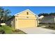 Side angle view of a lovely home with a two car garage and a well manicured lawn at 4357 Babbling Brook Way, Kissimmee, FL 34746