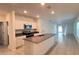 Open-concept kitchen featuring a large island, stainless steel appliances, and recessed lighting throughout at 4357 Babbling Brook Way, Kissimmee, FL 34746