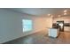 Living room featuring tile flooring, neutral paint, and access to the open kitchen at 4357 Babbling Brook Way, Kissimmee, FL 34746