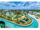 Aerial view of a resort-style pool area and lazy river with lush landscaping at 4888 Romeo Cir, Kissimmee, FL 34746