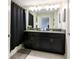 Well-appointed bathroom featuring a dual sink vanity and a shower with dark curtain at 4888 Romeo Cir, Kissimmee, FL 34746