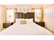 Comfortable bedroom with king bed, bedside tables, and window with natural light at 4888 Romeo Cir, Kissimmee, FL 34746