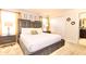 Bright bedroom featuring king bed, bedside tables, closet, and an ensuite bathroom at 4888 Romeo Cir, Kissimmee, FL 34746