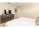 Cozy bedroom with dresser, TV, and comfortable bed, perfect for relaxation at 4888 Romeo Cir, Kissimmee, FL 34746