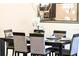 Dining room features a modern chandelier, dark wood table, and seating for six with a decorative mirror at 4888 Romeo Cir, Kissimmee, FL 34746