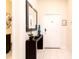 Entryway with a dark console table, decorative mirror, and tiled floors for a welcoming ambiance at 4888 Romeo Cir, Kissimmee, FL 34746