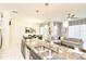 Open kitchen and living area featuring stainless steel appliances, granite counters, and pendant lighting at 4888 Romeo Cir, Kissimmee, FL 34746