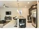Open-concept kitchen and living area with stainless steel appliances and a modern island at 4888 Romeo Cir, Kissimmee, FL 34746