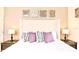 Bright main bedroom features a tufted headboard, decorative pillows, lamps, and nightstands at 4888 Romeo Cir, Kissimmee, FL 34746