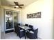 Covered patio features a ceiling fan and a dining table with six chairs at 4888 Romeo Cir, Kissimmee, FL 34746