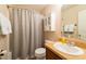 Bathroom featuring a shower with curtain and cabinet storage at 5101 Staniard Dr, Kissimmee, FL 34746