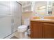 Well-lit bathroom featuring a shower, toilet, vanity with a sink and storage space at 5101 Staniard Dr, Kissimmee, FL 34746