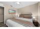 Cozy bedroom with queen bed, ceiling fan, and television for a relaxing retreat at 5101 Staniard Dr, Kissimmee, FL 34746