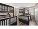 Spacious bedroom with hardwood floors, two bunk beds, and ample natural light at 5101 Staniard Dr, Kissimmee, FL 34746