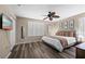 Comfortable bedroom with wood-look floors, shutters, and a ceiling fan at 5101 Staniard Dr, Kissimmee, FL 34746