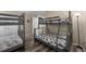 Bedroom featuring two bunk beds, hardwood floors, and plenty of natural light at 5101 Staniard Dr, Kissimmee, FL 34746