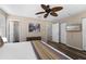 Bright bedroom with modern ceiling fan, wood floors, and ensuite bathroom at 5101 Staniard Dr, Kissimmee, FL 34746