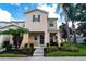 Inviting two-story home with well-manicured landscaping and an American flag, presenting a charming curb appeal at 5101 Staniard Dr, Kissimmee, FL 34746