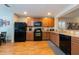 Well-equipped kitchen with wooden cabinets and black appliances, offering ample space for cooking at 5101 Staniard Dr, Kissimmee, FL 34746