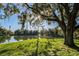 Scenic lake view with a bench under a tree offering a serene retreat within the community at 5101 Staniard Dr, Kissimmee, FL 34746