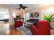 Open living room with a ceiling fan and a view into the kitchen, providing a seamless entertaining space at 5101 Staniard Dr, Kissimmee, FL 34746