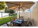Cozy outdoor patio with table, chairs, and shade umbrella at 5101 Staniard Dr, Kissimmee, FL 34746