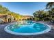 Community pool with lounge chairs and a tropical landscaping at 5101 Staniard Dr, Kissimmee, FL 34746