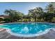 Inviting community pool surrounded by lush greenery, perfect for relaxation and recreation at 5101 Staniard Dr, Kissimmee, FL 34746