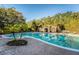 Large community swimming pool with lush tropical landscaping and deck chairs at 5101 Staniard Dr, Kissimmee, FL 34746