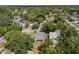 Single Gathering home surrounded by mature trees and a green lawn in a residential neighborhood at 514 Massachusetts Ave, St Cloud, FL 34769