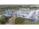 Aerial view of the docks and the two story building with a lush, treed background at 514 Massachusetts Ave, St Cloud, FL 34769