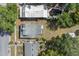 Overhead view of the property, with its cozy fire pit and adjacent homes, trees, and street at 514 Massachusetts Ave, St Cloud, FL 34769