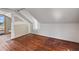 Unfinished attic with hardwood floors and natural light streaming through the window at 514 Massachusetts Ave, St Cloud, FL 34769