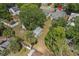 Aerial view of a home's backyard with a fenced yard, shed, and mature trees at 514 Massachusetts Ave, St Cloud, FL 34769