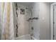 Well-lit bathroom featuring a tub with tiled walls, a shower head, and mosaic details at 514 Massachusetts Ave, St Cloud, FL 34769