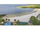Scenic beach view with sandy shore, clear blue water, palm trees, and park at 514 Massachusetts Ave, St Cloud, FL 34769