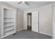 Bedroom featuring painted wood floors, ceiling fan, and built in shelves at 514 Massachusetts Ave, St Cloud, FL 34769
