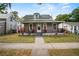 Charming two-story home featuring a cozy front porch and freshly manicured landscaping at 514 Massachusetts Ave, St Cloud, FL 34769