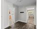Hallway leading to the kitchen and a brightly lit laundry room area at 514 Massachusetts Ave, St Cloud, FL 34769