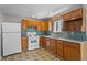 Kitchen featuring oak cabinets, tile backsplash, and stainless steel appliances at 514 Massachusetts Ave, St Cloud, FL 34769