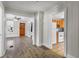 View of living room and kitchen with wood-look floors and lots of natural light at 514 Massachusetts Ave, St Cloud, FL 34769