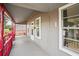 Inviting porch with red accents, offering a charming outdoor living space at 514 Massachusetts Ave, St Cloud, FL 34769