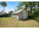 Shed with siding and a light colored roof in backyard with secure fencing at 514 Massachusetts Ave, St Cloud, FL 34769