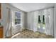 Sunroom features light-colored curtains and access to the outdoors at 514 Massachusetts Ave, St Cloud, FL 34769
