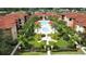 Beautiful aerial view showcasing the community pool and lush landscaping in a tropical setting at 5560 Metrowest Nw Blvd # 106, Orlando, FL 32811